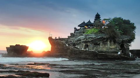 Balinese temple gate with worshippers in sarongs