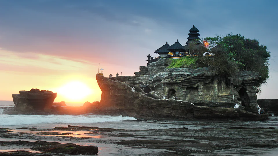Balinese temple gate with worshippers in sarongs